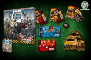 ra planszowa Monty Python’s Flying Circus: Zombicide z widocznym pudełkiem oraz rozłożonymi kartami postaci, akcji i broni. Na kartach przedstawione są postacie z charakterystycznym humorem Monty Pythona, takie jak policzkujący rybaka tancerz czy spam.